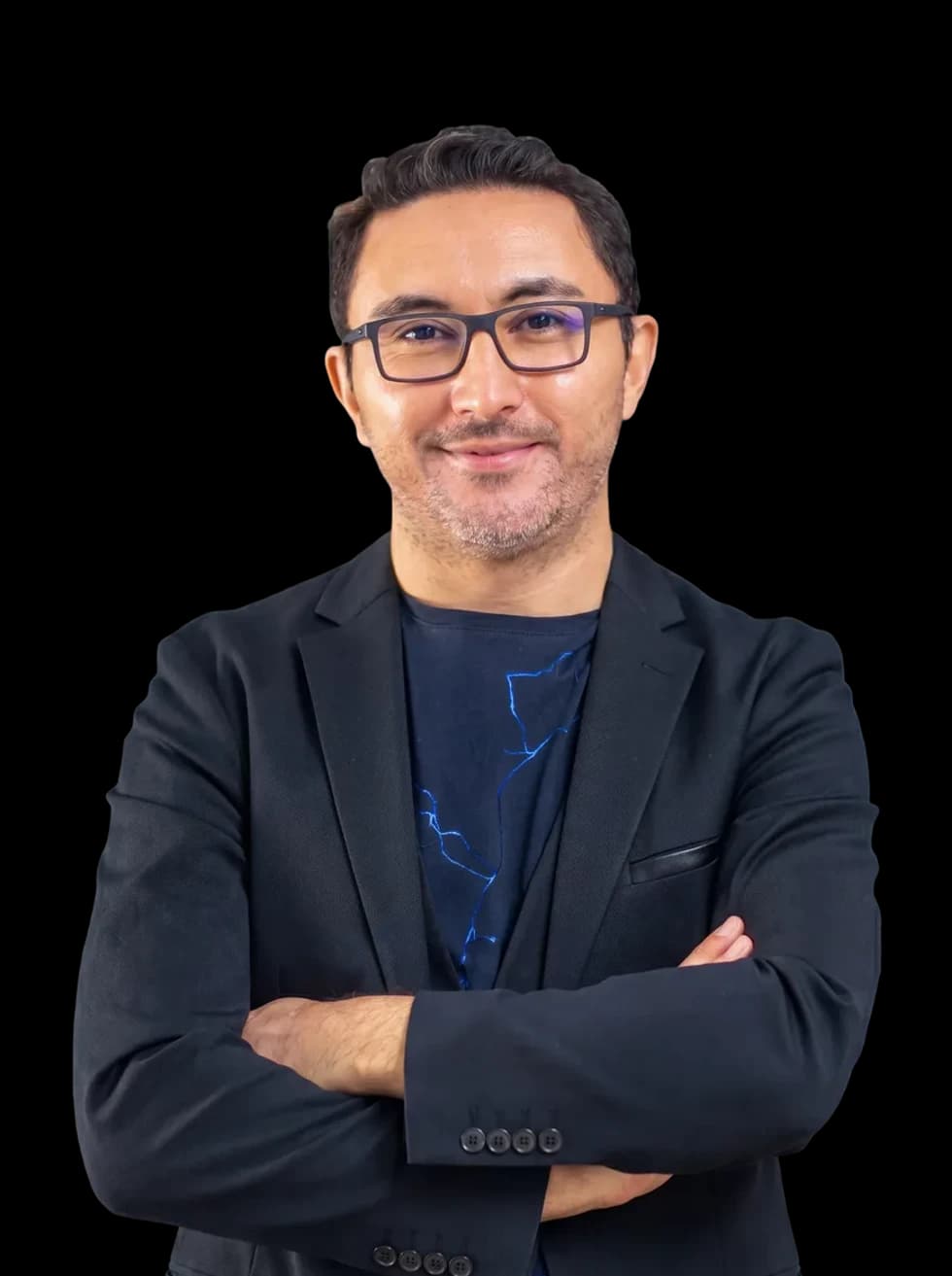 Portrait of Ömer Özkan, Chief Executive Officer, wearing glasses and a dark blazer with arms folded